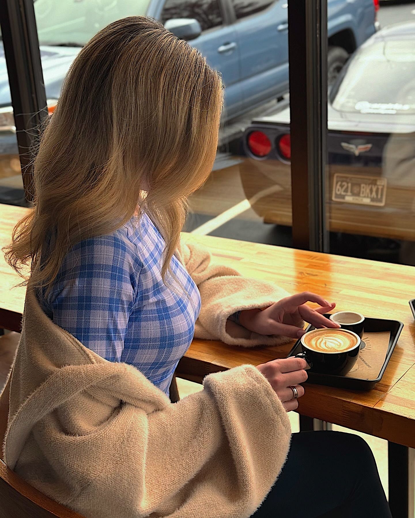 Women at a cafe wearing a Midnight Blue long sleeve crop top